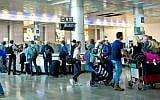Travelers seen at the arrival hall of Ben Gurion International Airport, near Tel Aviv, on April 11, 2018. (Moshe Shai/FLASH90)
