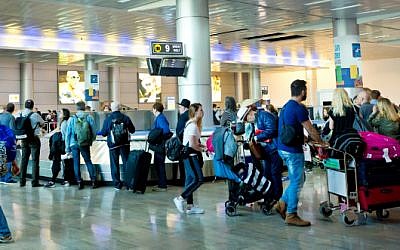 Travelers seen at the arrival hall of Ben Gurion International Airport, near Tel Aviv, on April 11, 2018. (Moshe Shai/FLASH90)