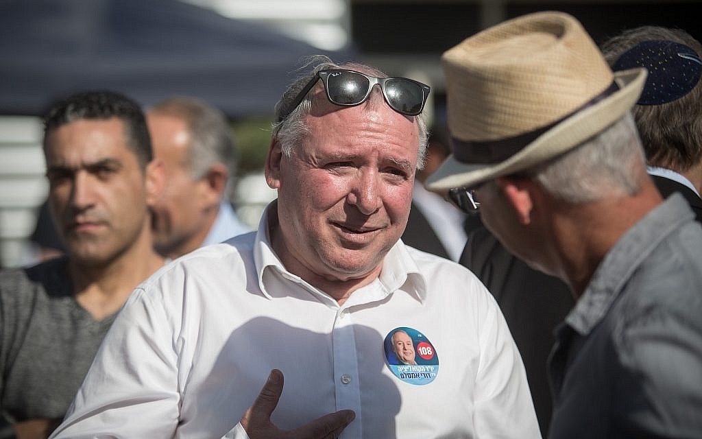 Coalition chairman David Amsalem with Likud supporters outside Tel Aviv Likud polling station on February 5, 2019 (Hadas Parush/Flash90)