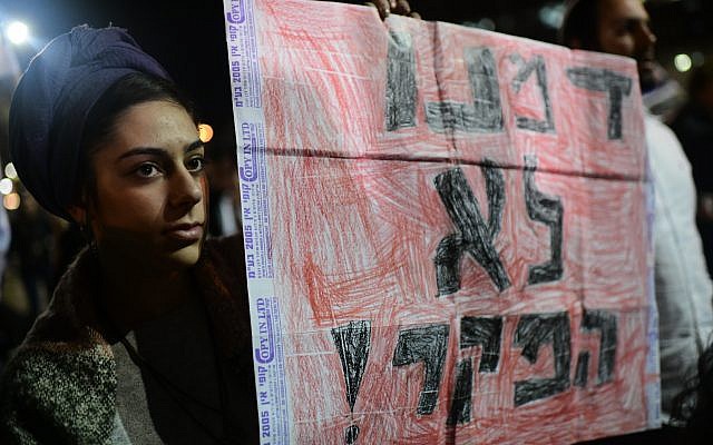An Israeli woman holds a sign reading 'Our blood is not worthless,' during a rally in Tel Aviv on February 9, 2019, following the murder of 19-year-old Ori Ansbacher. (Tomer Neuberg/Flash90) An Israeli woman holds a sign reading 'Our blood is not worthless,' during a rally in Tel Aviv on February 9, 2019, following the murder of 19-year-old Ori Ansbacher. (Tomer Neuberg/Flash90)