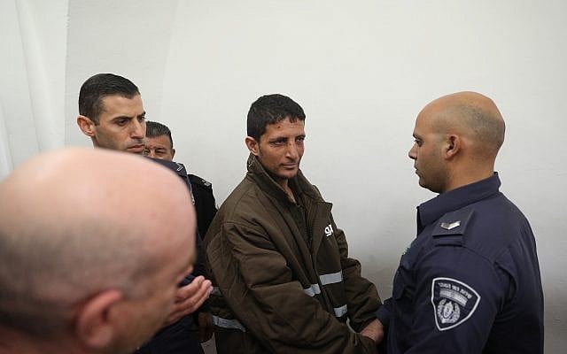 Police escort Arafat Irfaiya , charged with the murder of 19-year-old Ori Ansbacher, at the Jerusalem Magistrate's court, on February 11, 2019. (Yonatan Sindel/Flash90) Police escort Arafat Irfaiya , charged with the murder of 19-year-old Ori Ansbacher, at the Jerusalem Magistrate's court, on February 11, 2019. (Yonatan Sindel/Flash90)