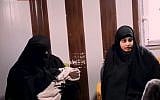 Screen capture from video of an interview with Shamima Begum, right, a British teen who joined the Islamic State. Her newborn baby is held by a woman, left, during the interview from Syria, February 2019. (YouTube)
