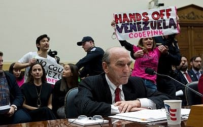 US Special Representative for Venezuela Elliott Abrams testifies as demonstrators protest behind him during the House Foreign Affairs subcommittee hearing on Venezuela at Capitol Hill in Washington, February 13, 2019. (AP Photo/Jose Luis Magana) US Special Representative for Venezuela Elliott Abrams testifies as demonstrators protest behind him during the House Foreign Affairs subcommittee hearing on Venezuela at Capitol Hill in Washington, February 13, 2019. (AP Photo/Jose Luis Magana)