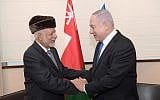 Prime Minister Benjamin Netanyahu (right) greets Omani Foreign Minister Yusuf bin Alawi bin Abdullah at the sidelines of a regional conference on the Middle East in Warsaw, February 13, 2018. (Amos Ben Gershom/GPO)