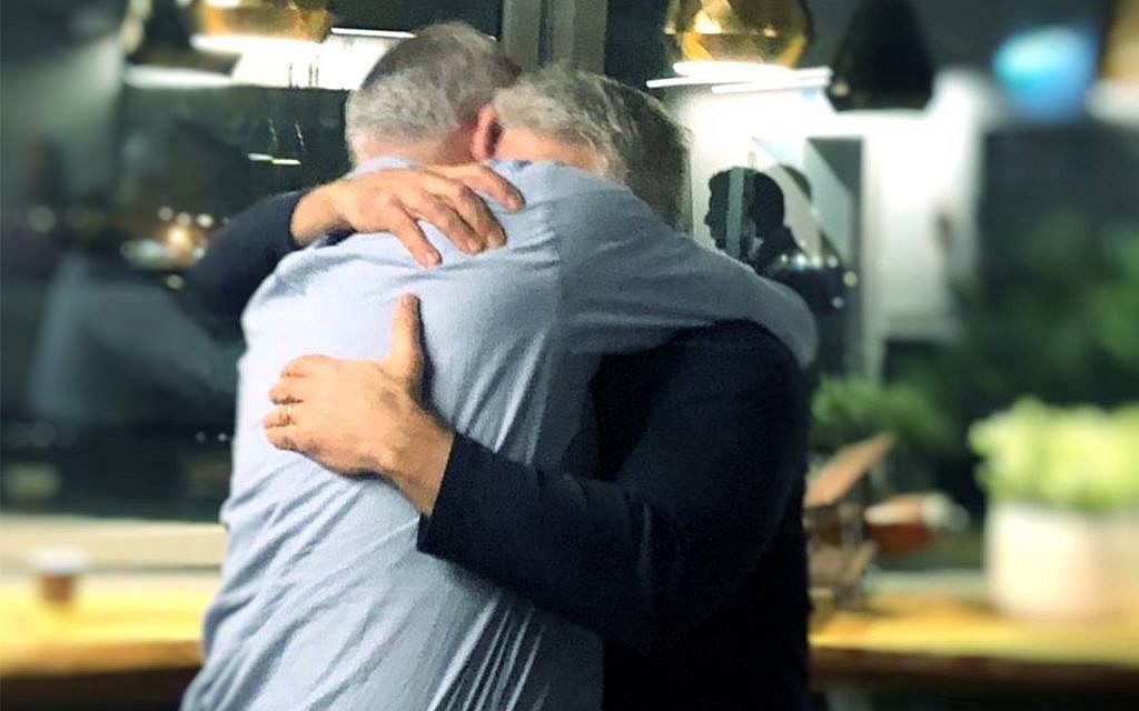 Benny Gantz and Yair Lapid embrace after deciding to forge an alliance for the upcoming election, February 21, 2019. (Courtesy/Facebook) Benny Gantz and Yair Lapid embrace after deciding to forge an alliance for the upcoming election, February 21, 2019. (Courtesy/Facebook)