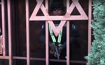 A guard seen outside a Jewish school and synagogue in Los Angeles before shooting the person filming the scene in the leg, on February 14, 2019. (screen capture: YouTube)