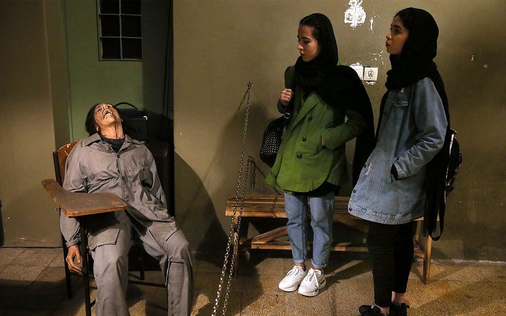 Women look at an exhibition at a former prison run by the pre-revolution intelligence service, SAVAK, now a museum, where a wax mannequin of a tortured female prisoner is on display, in downtown Tehran, Iran, January 7, 2019. (AP Photo/Ebrahim Noroozi)
