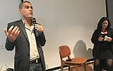 Mossi Raz speaking to an audience in Tel Aviv on February 21, 2019; at right is Times of Israel's Miriam Herschlag. (Simona Weinglass/Times of Israel)
