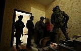 Israeli security forces arrest a Palestinian man in Ramallah suspected in the murder of Israeli teen Ori Ansbacher on February 8, 2019. (Israel Police)