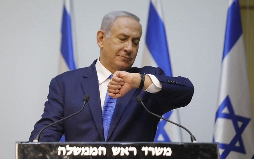 Prime Minister Benjamin Netanyahu prepares to deliver a statement at the Knesset, December 9, 2018. (MENAHEM KAHANA / AFP) Prime Minister Benjamin Netanyahu prepares to deliver a statement at the Knesset, December 9, 2018. (MENAHEM KAHANA / AFP)