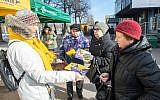 A member of the Reform party (L) hands over leaflets on March 2, 2019 in Tallinn, on the eve of Estonia's general elections. (Raigo Pajula / AFP)