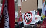 A protester holds a sign depicting Austria's Chancellor Sebastian Kurz, left, and Austrian Vice Chancellor Heinz-Christian Strache during a rally in Vienna, December 15, 2018. (ALEX HALADA/AFP)