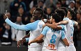 Marseille's Italian forward Mario Balotelli (L) takes a selfie with teammates after scoring during the French L1 football match between Olympique de Marseille and AS Saint-Etienne at the Velodrome Stadium in Marseille, southern France on March 3, 2019. (Photo by GERARD JULIEN / AFP)