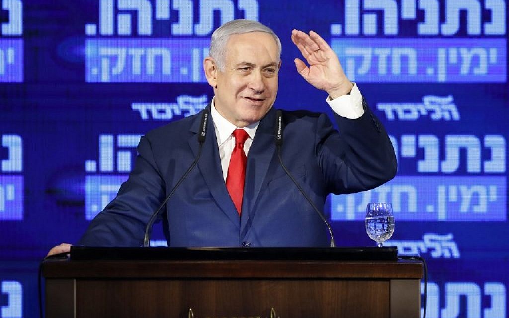 Prime Minister Benjamin Netanyahu waves, as he delivers a speech during the launch of his election campaign at the headquarters of his party Likud, for the upcoming April elections, in Ramat Gan on March 4, 2019. (Jack GUEZ / AFP)
