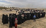 Civilians evacuated from the Islamic State group's embattled holdout of Baghouz wait at a screening area held by the US-backed Kurdish-led Syrian Democratic Forces (SDF), in the eastern Syrian province of Deir Ezzor, on March 5, 2019 (Bulent KILIC / AFP)