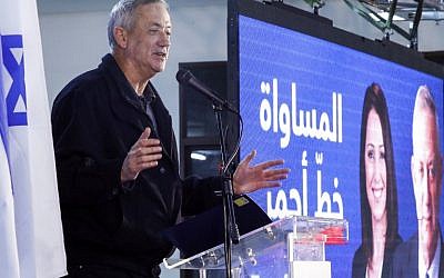 Retired Israeli army general Benny Gantz, one of the leaders of the Blue and White political alliance, speaks next to a large screen depicting his face next to a caption in Arabic reading "equality is a red line," as he addresses members of the Druze community of Israel in the city of Daliyat al-Karmel in northern Israel on March 7, 2019. (Photo by JACK GUEZ / AFP)