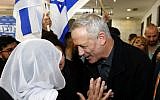 Benny Gantz, center, leader of the Blue and White faction, speaks to a woman during a meeting with members of the Druze community in the city of Daliyat al-Karmel on March 7, 2019. (Jack Guez/AFP)