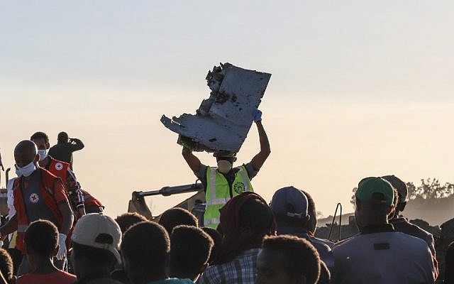 A man carries a piece of debris on his head at the crash site of a Nairobi-bound Ethiopian Airlines flight near Bishoftu, a town some 60 kilometers (37 miles) southeast of Addis Ababa, Ethiopia, on March 10, 2019. (Michael TEWELDE / AFP) A man carries a piece of debris on his head at the crash site of a Nairobi-bound Ethiopian Airlines flight near Bishoftu, a town some 60 kilometers (37 miles) southeast of Addis Ababa, Ethiopia, on March 10, 2019. (Michael TEWELDE / AFP)