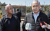 Ariel Mayor Eli Sheviro (L) stands next to Prime Minister Benjamin Netanyahu visits the site of a terror attack at Ariel Junction in the northern West Bank, March 18, 2019. (Jack Guez / POOL / AFP)