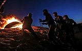 Palestinians take part in a night demonstration near the fence along the border with Israel, in Rafah in the southern Gaza Strip, on March 19, 2019. (Said Khatib/AFP)