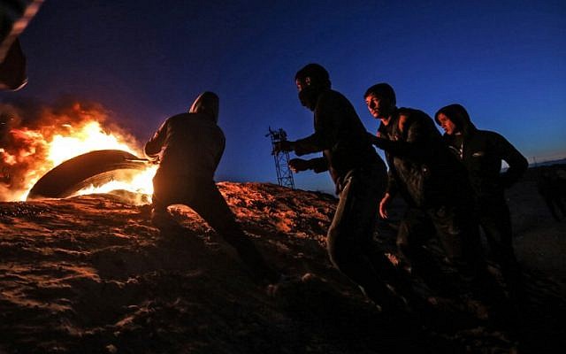 Palestinians take part in a night demonstration near the fence along the border with Israel, in Rafah in the southern Gaza Strip, on March 19, 2019. (Said Khatib/AFP) Palestinians take part in a night demonstration near the fence along the border with Israel, in Rafah in the southern Gaza Strip, on March 19, 2019. (Said Khatib/AFP)