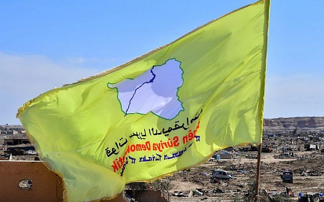 A picture taken on March 23, 2019 shows the US-backed Syrian Democratic Forces' (SDF) flag atop a building in the Islamic State group's last bastion in the eastern Syrian village of Baghouz after defeating the jihadist group (Giuseppe CACACE / AFP) A picture taken on March 23, 2019 shows the US-backed Syrian Democratic Forces' (SDF) flag atop a building in the Islamic State group's last bastion in the eastern Syrian village of Baghouz after defeating the jihadist group (Giuseppe CACACE / AFP)