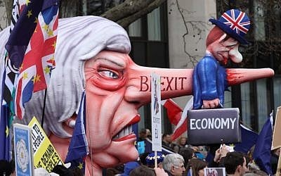 A puppet head of Britain's Prime Minister Theresa May spearing a representation of the British Economy is taken on a march and rally organized by the pro-European People's Vote campaign for a second EU referendum in central London on March 23, 2019. (Isabel Infantes/AFP)