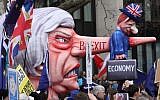 A puppet head of Britain's Prime Minister Theresa May spearing a representation of the British Economy is taken on a march and rally organized by the pro-European People's Vote campaign for a second EU referendum in central London on March 23, 2019. (Isabel Infantes/AFP)