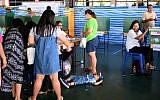 A child lies on the floor as voters cast their ballots at a polling station in Bangkok on March 24, 2019, during Thailand's general election. (Jewel SAMAD / AFP)