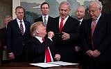 US President Donald Trump hands his pen to Prime Minister Benjamin Netanyahu after signing a Proclamation on the Golan Heights in the Diplomatic Reception Room at the White House, March 25, 2019. (Saul Loeb/AFP)