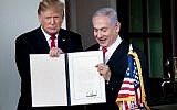 US President Donald Trump (L) and Prime Minister Benjamin Netanyahu hold up a Golan Heights proclamation outside the West Wing after a meeting in the White House March 25, 2019 in Washington, DC. (Brendan Smialowski / AFP)