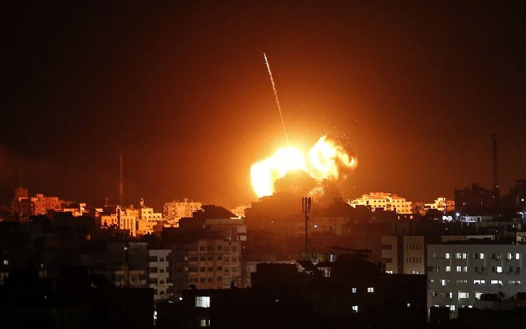 A ball of fire lights the sky above a building believed to house the offices of Hamas chairmain Ismail Haniyeh, during Israeli strikes on Gaza City hours after a rocket from the Palestinian enclave hit a house and wounded seven Israelis on March 25, 2019. (Mahmud Hams / AFP)
