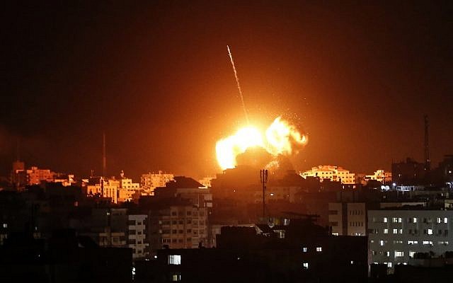 A ball of fire lights the sky above a building believed to house the offices of Hamas chairmain Ismail Haniyeh, during Israeli strikes on Gaza City hours after a rocket from the Palestinian enclave hit a house and wounded seven Israelis on March 25, 2019. (Mahmud Hams / AFP)
