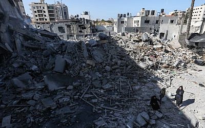 A picture taken on March 26, 2019, shows Palestinians gathering next to the rubble of a building in Gaza City, after Israeli air strikes hit dozens of sites across the Strip overnight in response to rocket fire from the Palestinian enclave. (Mahmud Hams/AFP) A picture taken on March 26, 2019, shows Palestinians gathering next to the rubble of a building in Gaza City, after Israeli air strikes hit dozens of sites across the Strip overnight in response to rocket fire from the Palestinian enclave. (Mahmud Hams/AFP)