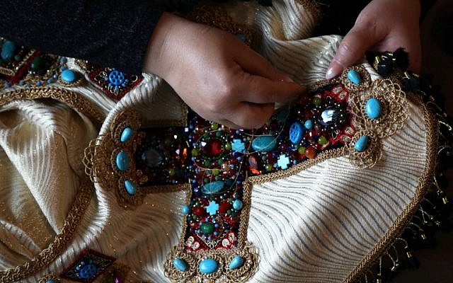 Iraqi Kurdish artist Shanaz Jamal, 40, embroiders a robe ornated with a big cross, one of the religious symbols of communities living in Iraq's multi-ethnic north, in Arbil, the capital of the Kurdish autonomous region, on March 27, 2019. (Photo by SAFIN HAMED / AFP) Iraqi Kurdish artist Shanaz Jamal, 40, embroiders a robe ornated with a big cross, one of the religious symbols of communities living in Iraq's multi-ethnic north, in Arbil, the capital of the Kurdish autonomous region, on March 27, 2019. (Photo by SAFIN HAMED / AFP)