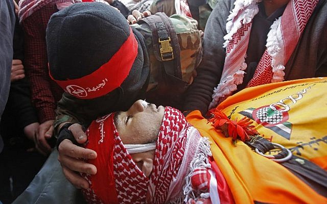 A member of the Popular Front for the Liberation of Palestine terror group kisses the head of Sajid Muzher, 17, after he was reported killed by Israeli fire during clashes in the Dheisheh refugee camp near the West Bank city of Bethlehem, during his funeral on March 27, 2019. (Musa Al Shaer/AFP) A member of the Popular Front for the Liberation of Palestine terror group kisses the head of Sajid Muzher, 17, after he was reported killed by Israeli fire during clashes in the Dheisheh refugee camp near the West Bank city of Bethlehem, during his funeral on March 27, 2019. (Musa Al Shaer/AFP)