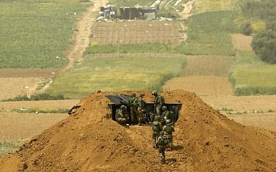 Illustrative: Israeli soldiers gather at a position on the border with the Gaza Strip near Kibbutz Nahal Oz in southern Israel on March 30, 2019. (Jack Guez/AFP)