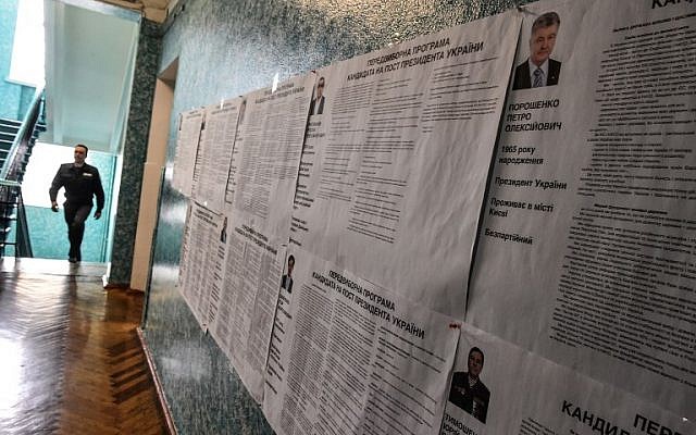 A security officer walks past voting information boards on candidates at a polling station in the center of Kiev on March 30, 2019 ahead of the Ukrainian presidential election on March 30. (Vasily Maximov/AFP) A security officer walks past voting information boards on candidates at a polling station in the center of Kiev on March 30, 2019 ahead of the Ukrainian presidential election on March 30. (Vasily Maximov/AFP)