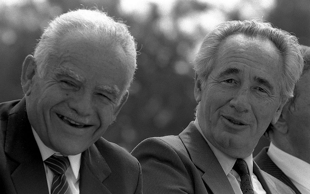 Then-prime minister Yitzhak Shamir (left) and then-foreign minister Shimon Peres at a Mimouna celebration at Sacher Park in Jerusalem, March 15, 1988. (Nati Harnik/Government Press Office)