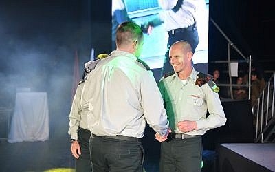 Brigadier-General Rafi Milo, commander of the 91st Galilee Division (right), awards a citation to Major Y of the Engineering Corps for his part in Operation Northern Shield. (IDF)