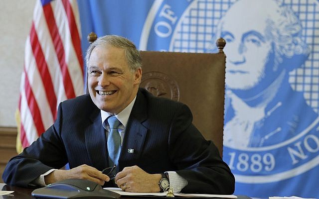 In this Wednesday, Feb. 27, 2019 photo, Washington Gov. Jay Inslee sits in front of the state seal as he takes part in a conference call meeting with members of the AARP, at the Capitol in Olympia, Wash. (AP Photo/Ted S. Warren) In this Wednesday, Feb. 27, 2019 photo, Washington Gov. Jay Inslee sits in front of the state seal as he takes part in a conference call meeting with members of the AARP, at the Capitol in Olympia, Wash. (AP Photo/Ted S. Warren)