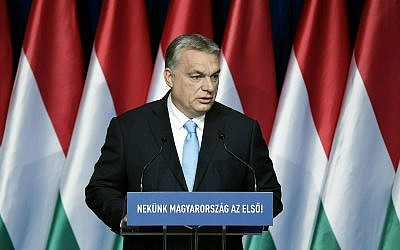 In this Sunday, February 10, 2019 file photo, Hungarian Prime Minister Viktor Orban delivers his annual "State of Hungary" speech in Budapest, Hungary. The inscription reads: "For us Hungary is the first!" (Szilard Koszticsak/MTI via AP, File)