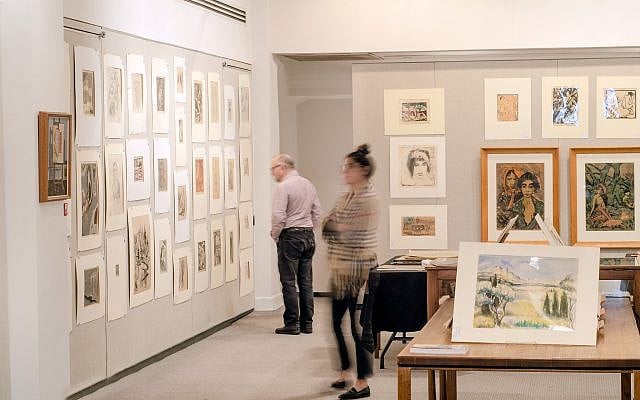In this undated photo people look at some of the art which is going up for auction at Swann Auction Galleries in New York that were once part of a 6,000-piece collection amassed by a Jewish attorney in Germany before pieces were scattered and lost as the Nazis took over. The works collected by Ismar Littmann being offered Tuesday, March 5, 2019, at Swann are mostly drawings, etchings and lithographs. (Lauren Kristin/Swan Auction Galleries via AP) In this undated photo people look at some of the art which is going up for auction at Swann Auction Galleries in New York that were once part of a 6,000-piece collection amassed by a Jewish attorney in Germany before pieces were scattered and lost as the Nazis took over. The works collected by Ismar Littmann being offered Tuesday, March 5, 2019, at Swann are mostly drawings, etchings and lithographs. (Lauren Kristin/Swan Auction Galleries via AP)