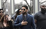 Empire actor Jussie Smollett, center, arrives at the Leighton Criminal Court Building for his hearing on Thursday, March 14, 2019, in Chicago. (AP Photo/Matt Marton)