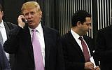 In this photo from September 14, 2005, Donald Trump, left, talks on his cellphone with Felix Sater, right, outside after speaking at the Bixpo 2005 business convention at the Budweiser Events Center in Loveland, Colorado. (Cyrus McCrimmon/The Denver Post via AP)
