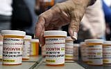 Illustrative: In this photo from August 17, 2018, family and friends who have lost loved ones to OxyContin and opioid overdoses leave pill bottles in protest outside the headquarters of Purdue Pharma, which is owned by the Sackler family, in Stamford, Connecticut. (AP Photo/Jessica Hill)