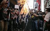 Illustrative: Demonstrators burn an Israeli flag during a protest outside Israel's embassy in Caracas, January 8, 2009. (AP Photo/Fernando Llano)
