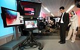 In this June 26, 2009 file photo BBC Persian service presenter Fardad Farahzad, right, gets ready to present the news, at the corporation's London headquarters  Inside the studios of BBC Persian television, dozens of journalists have been working around the clock at their computers and telephones, trying to report the news to Iran or, according to the government in Tehran, stirring up trouble. (AP Photo/Simon Dawson,file)
