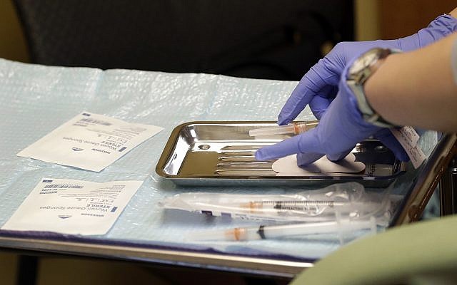 A health care worker prepares syringes, including a vaccine for measles, mumps, and rubella (MMR), for a child's inoculations at the International Community Health Services, February 13, 2019, in Seattle, Washington. (AP Photo/Elaine Thompson) A health care worker prepares syringes, including a vaccine for measles, mumps, and rubella (MMR), for a child's inoculations at the International Community Health Services, February 13, 2019, in Seattle, Washington. (AP Photo/Elaine Thompson)