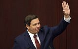Florida Governor Ron DeSantis waves to the gallery as he makes his state of the state speech on the first day of legislative session, March 5, 2019, in Tallahassee, Florida. (AP Photo/Steve Cannon)